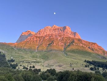 Scenic view of mountains against clear blue sky