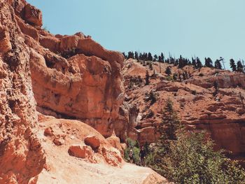 Rock formations on landscape against clear sky