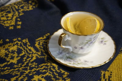 High angle view of a cup of tea with lemon  slice on the table