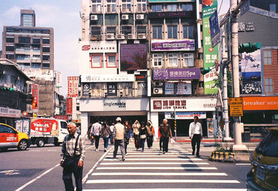 People crossing road in city