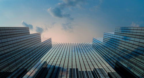 Low angle view of modern buildings against sky during sunset