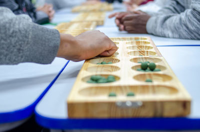 Cropped hand of person holding dices