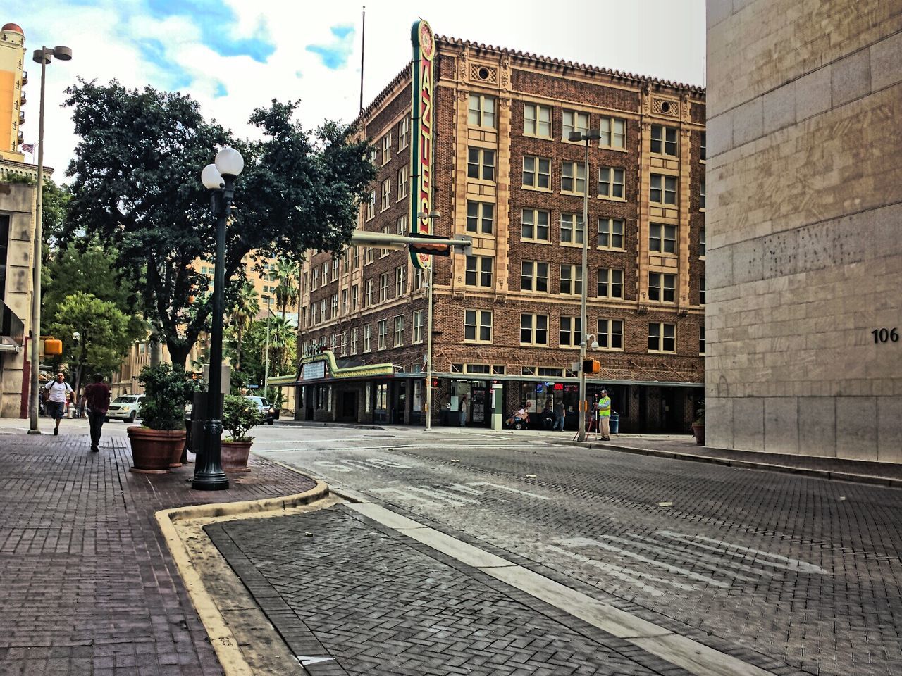 building exterior, architecture, built structure, city, street, sky, building, the way forward, transportation, incidental people, sidewalk, tree, cobblestone, day, city life, residential building, outdoors, road, residential structure, cloud - sky