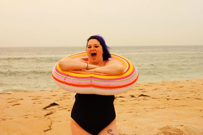 Young woman standing on beach