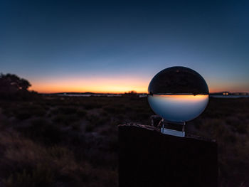 Close-up of silhouette land against clear sky during sunset