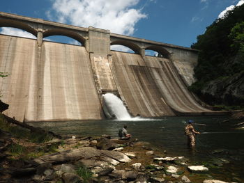 View of dam on bridge against sky