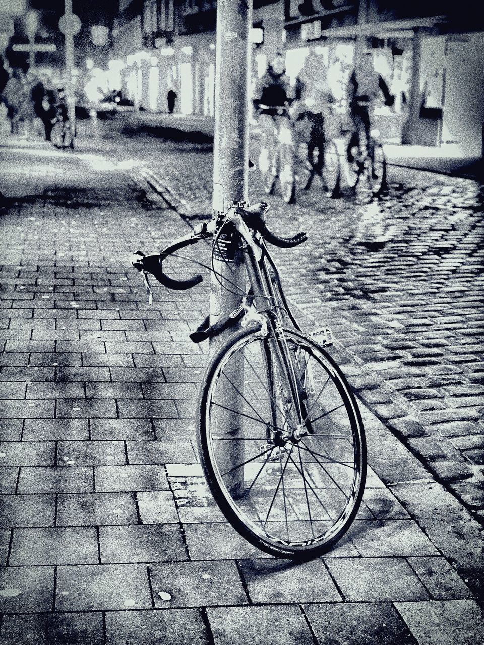 BICYCLE PARKED ON SIDEWALK BY STREET