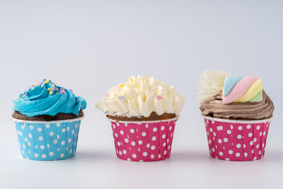 Variety of cupcakes against white background
