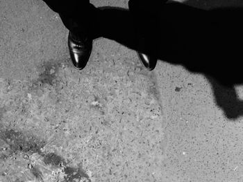 Low section of person standing on tiled floor