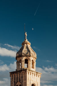 Low angle view of bell tower against sky