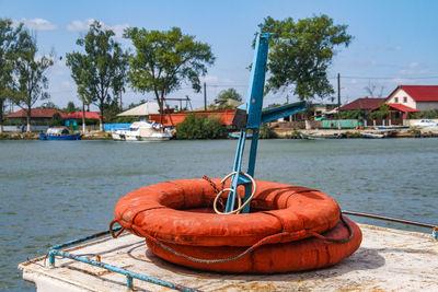 Boat moored at harbor against sky