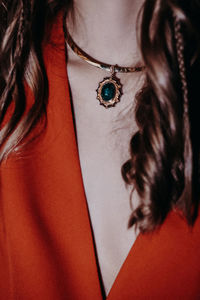 Golden jewelry hanging on a woman's neck