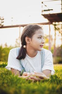 Close-up of girl looking away on field