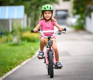Portrait of happy girl riding bicycle