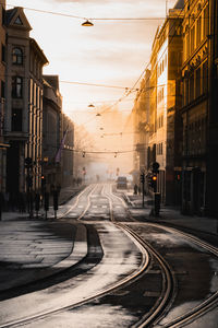 View of railroad tracks amidst buildings in city