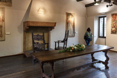 Woman standing on wooden table at home