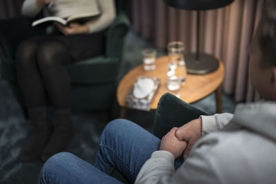 Man wringing hands at therapy session