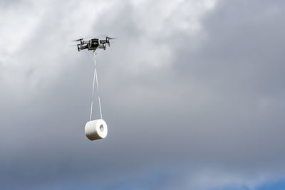 The drone is flying with the toilet paper roll to the customer, concept of drone delivery