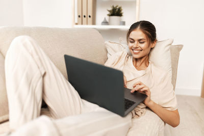 Young woman using laptop at home