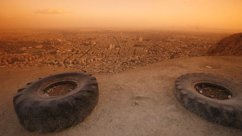 High angle view of tires on cliff at sunset