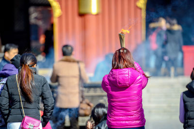 Rear view of people walking outdoors