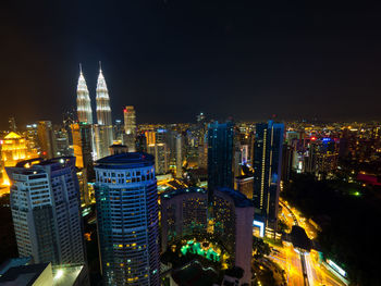 High angle view of city lit up at night