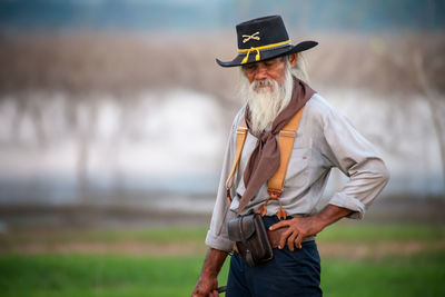 Senior man standing on field