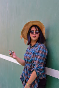 Portrait of woman wearing sunglasses standing outdoors