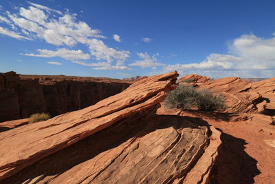 Scenic view of desert against cloudy sky