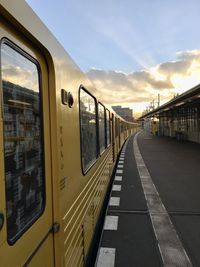 Train at railroad station platform against sky