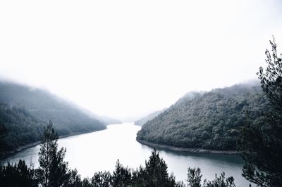 Scenic view of lake and mountains against clear sky