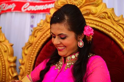 Portrait of smiling woman with pink mask