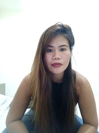 Portrait of beautiful young woman sitting at home