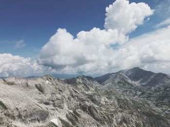Scenic view of mountains against cloudy sky