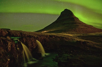 The sky was lit up by magnificent northern light at this iconic mountain of iceland.