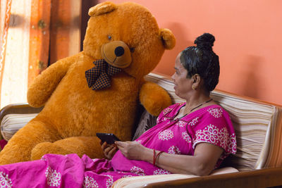 Rear view of girl using mobile phone