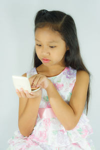Girl looking away while using smart phone