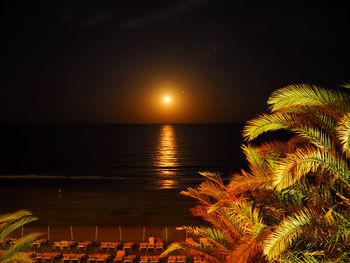 Scenic view of sea against clear sky at night