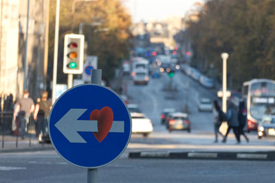 Close-up of road arrow sign on street