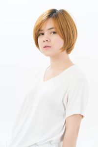 Portrait of a teenage girl against white background