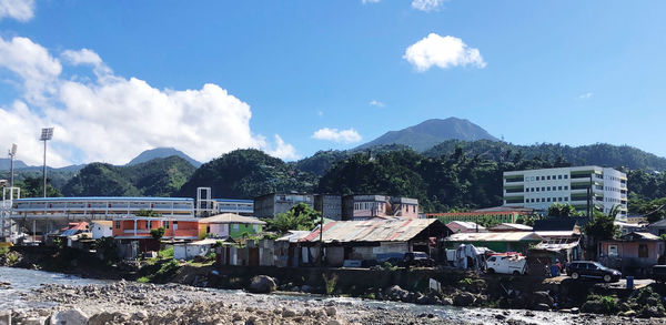 Houses by mountains against sky