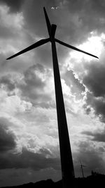 Low angle view of silhouette windmill against sky