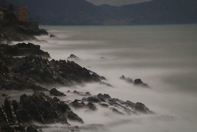 Scenic view of sea and mountains at sunset