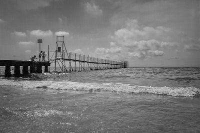 Pier over sea against sky