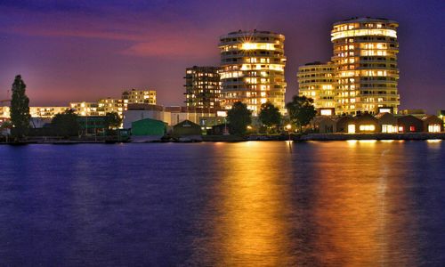 Illuminated city against sky at night