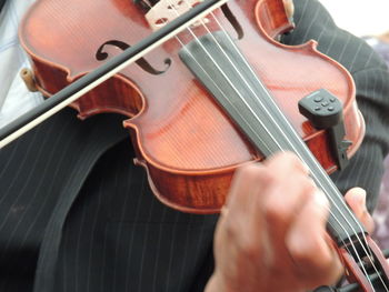 Close-up of man playing guitar