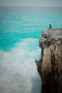 Man surfing in sea against sky