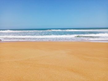 Scenic view of beach against clear sky