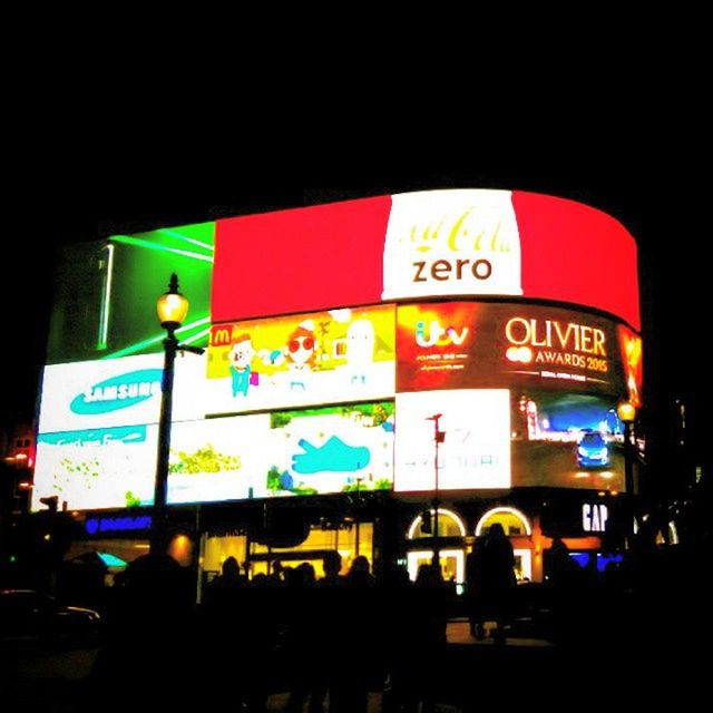 text, illuminated, night, western script, built structure, communication, architecture, non-western script, building exterior, men, clear sky, advertisement, information sign, city, low angle view, sign, street, multi colored, leisure activity