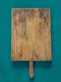 High angle view of wooden table against blue background